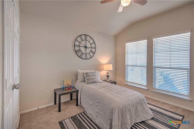 bedroom featuring ceiling fan, baseboards, vaulted ceiling, and light colored carpet