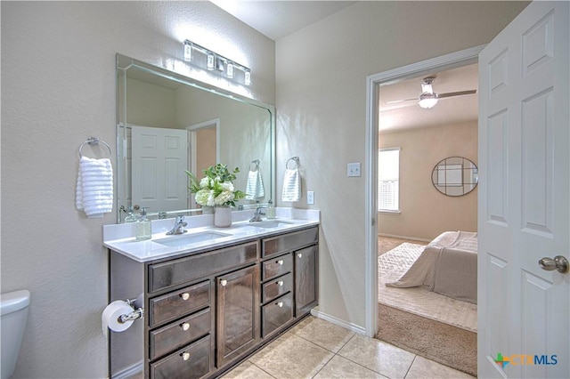 ensuite bathroom with double vanity, ensuite bath, tile patterned flooring, and a sink