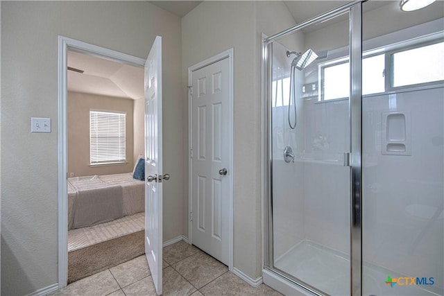 bathroom featuring connected bathroom, an enclosed shower, baseboards, and tile patterned floors