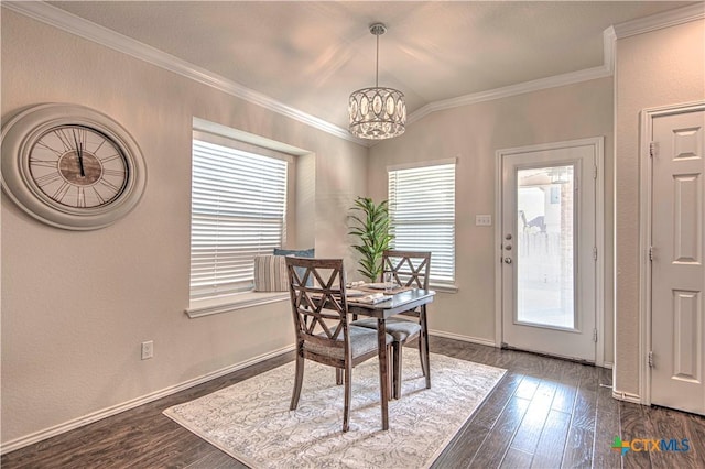 dining space featuring ornamental molding, dark wood-type flooring, baseboards, and a notable chandelier