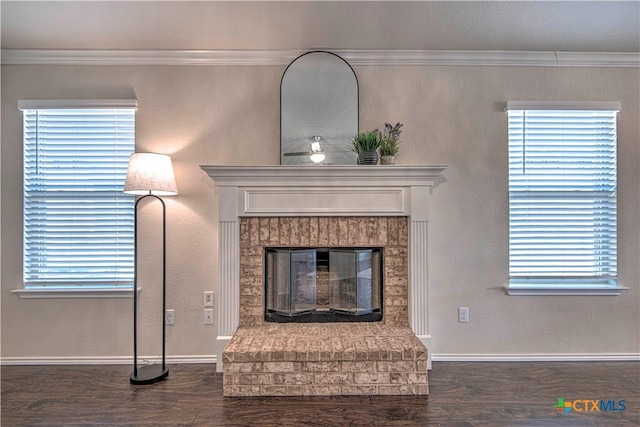 room details with a brick fireplace, baseboards, ornamental molding, and wood finished floors