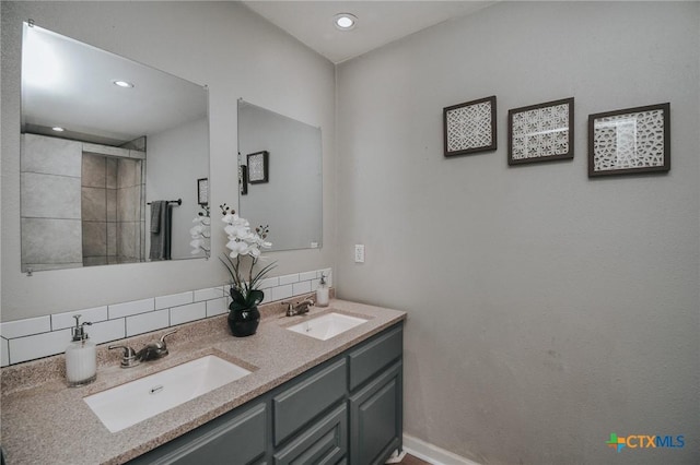 bathroom featuring a sink, recessed lighting, and double vanity