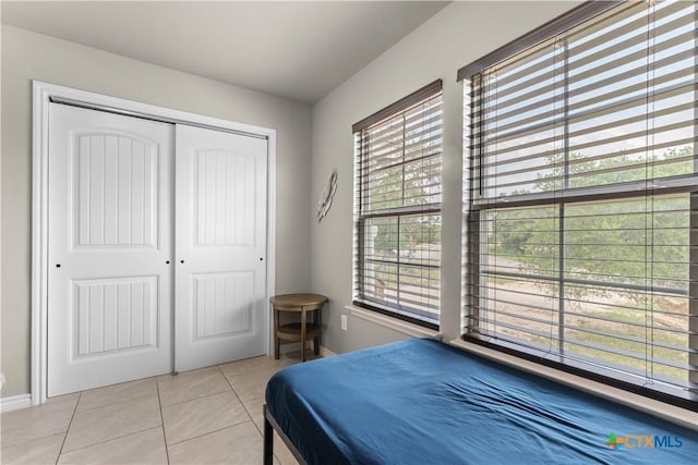 2319 Westview Dr, Canyon Lake, TX 78133 - tiled bedroom featuring baseboards, a closet, and multiple windows