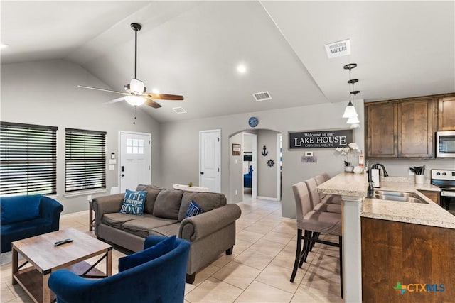 2319 Westview Dr, Canyon Lake, TX 78133 - living area featuring arched walkways, light tile patterned flooring, visible vents, ceiling fan, and high vaulted ceiling