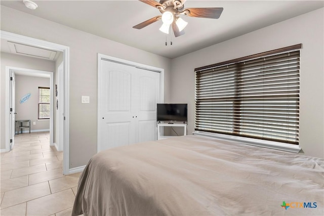 2319 Westview Dr, Canyon Lake, TX 78133 - bedroom featuring attic access, baseboards, a closet, ceiling fan, and light tile patterned floors