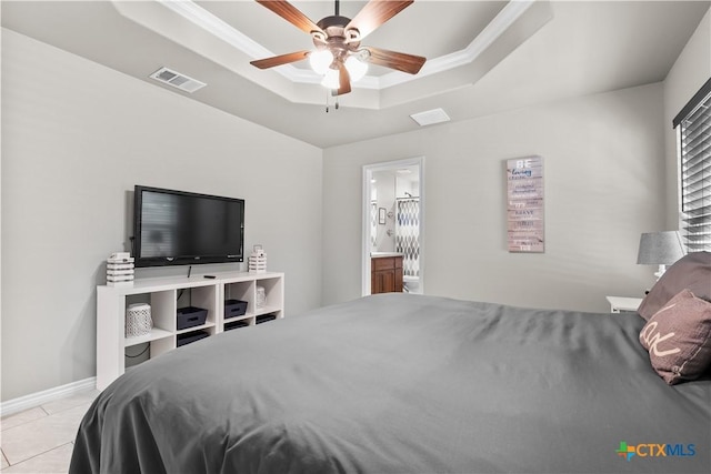 2319 Westview Dr, Canyon Lake, TX 78133 - bedroom with connected bathroom, light tile patterned flooring, a raised ceiling, ornamental molding, and visible vents