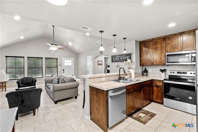 2319 Westview Dr, Canyon Lake, TX 78133 - kitchen featuring visible vents, a sink, arched walkways, appliances with stainless steel finishes, and open floor plan