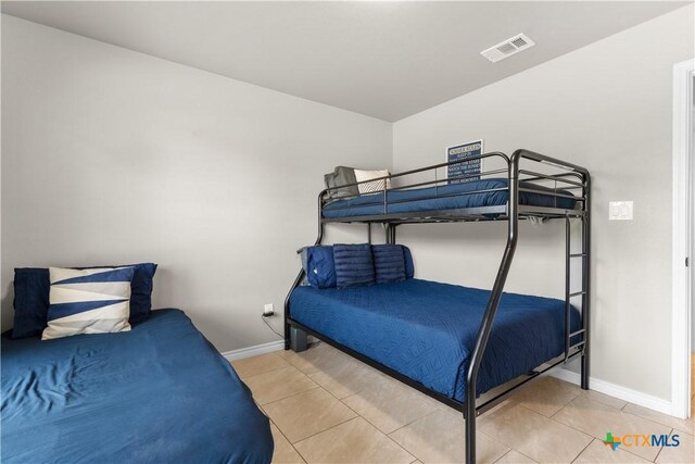2319 Westview Dr, Canyon Lake, TX 78133 - bedroom with baseboards, tile patterned flooring, and visible vents