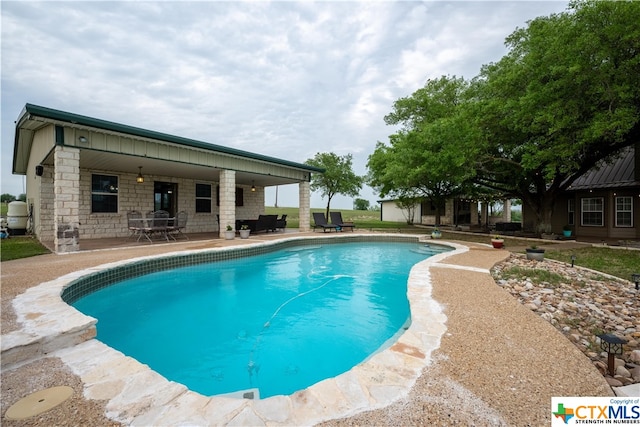 view of pool featuring a patio