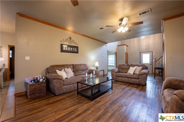 living room featuring a textured ceiling, dark hardwood / wood-style floors, ceiling fan, and crown molding