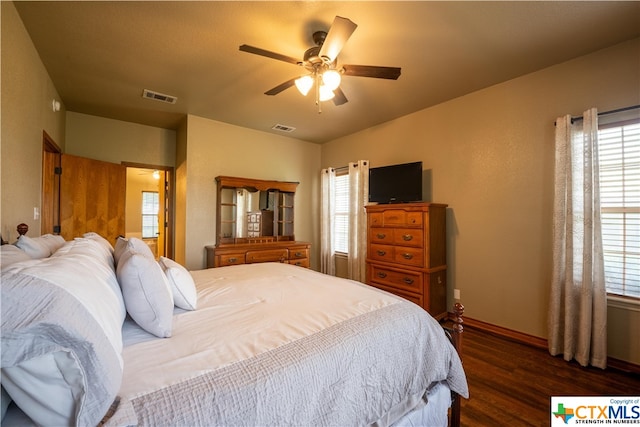 bedroom with multiple windows, ceiling fan, and dark hardwood / wood-style floors