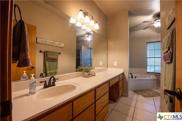 bathroom with vanity, a tub to relax in, tile patterned flooring, and ceiling fan