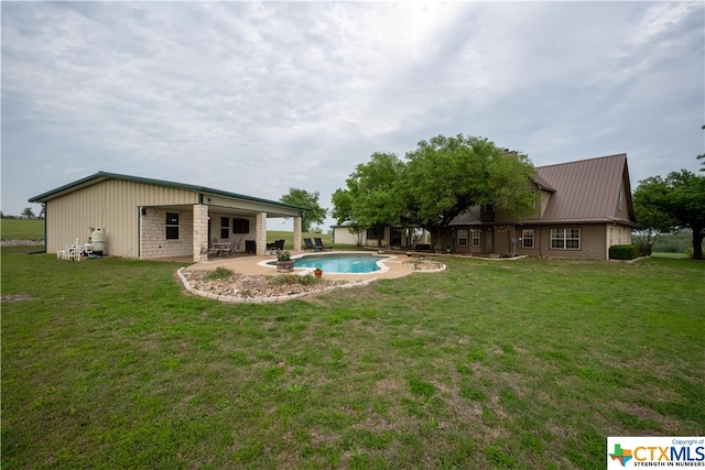 rear view of house with a patio and a lawn