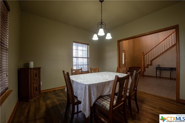 dining area with a chandelier and dark hardwood / wood-style floors