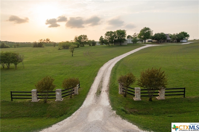 view of home's community featuring a rural view and a lawn