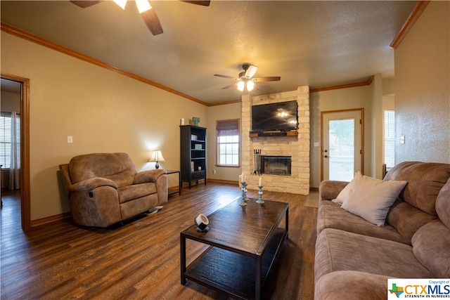 living room with a textured ceiling, dark wood-type flooring, ceiling fan, and crown molding