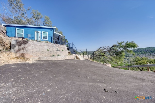 482 Dusty Saddle, Canyon Lake, TX 78133 - view of asphalt driveway with stairs