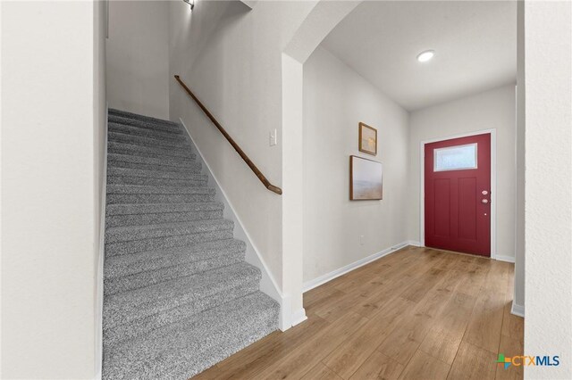 1044 Shelby Dr, Belton, TX 76513 - entryway featuring stairway, wood finished floors, arched walkways, and baseboards