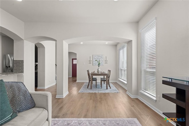 1044 Shelby Dr, Belton, TX 76513 - dining space with light wood-type flooring, arched walkways, and baseboards