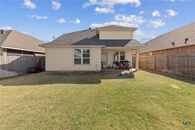 1044 Shelby Dr, Belton, TX 76513 - back of house featuring a patio, a lawn, a fenced backyard, and a shingled roof