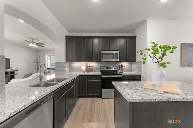 1044 Shelby Dr, Belton, TX 76513 - kitchen featuring a sink, light stone countertops, tasteful backsplash, and stainless steel appliances