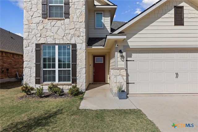 1044 Shelby Dr, Belton, TX 76513 - view of exterior entry featuring stone siding, a lawn, driveway, and an attached garage