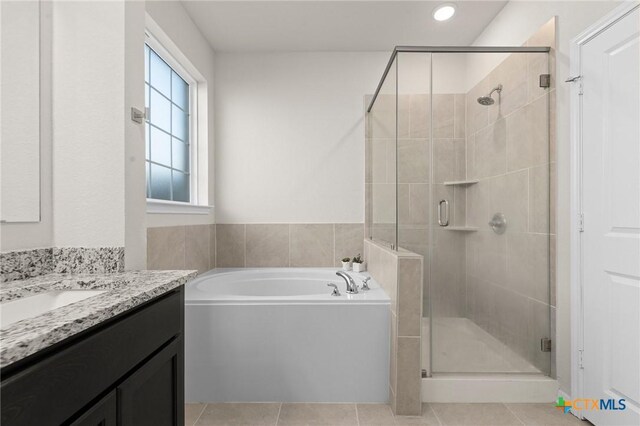 1044 Shelby Dr, Belton, TX 76513 - full bathroom featuring tile patterned flooring, a shower stall, vanity, and a garden tub