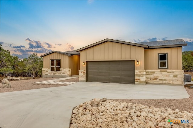 view of front of house with central AC and a garage