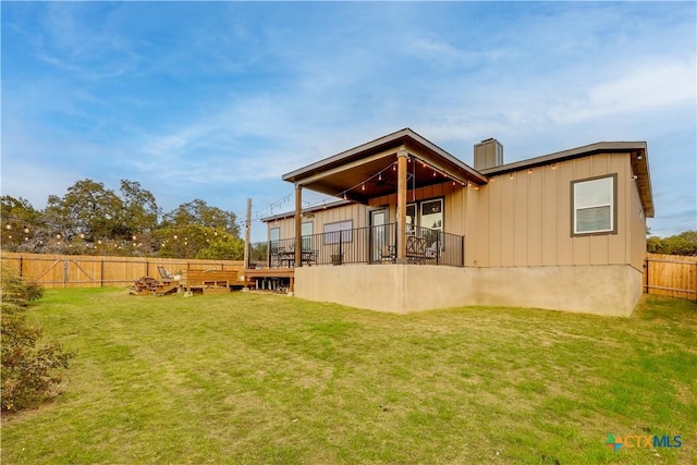 rear view of property featuring a lawn