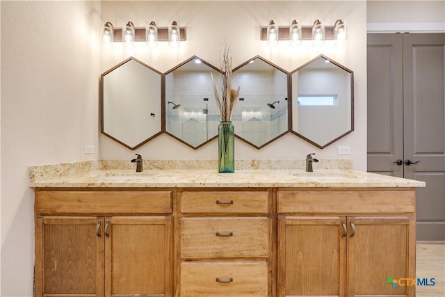 bathroom with hardwood / wood-style flooring, vanity, and walk in shower