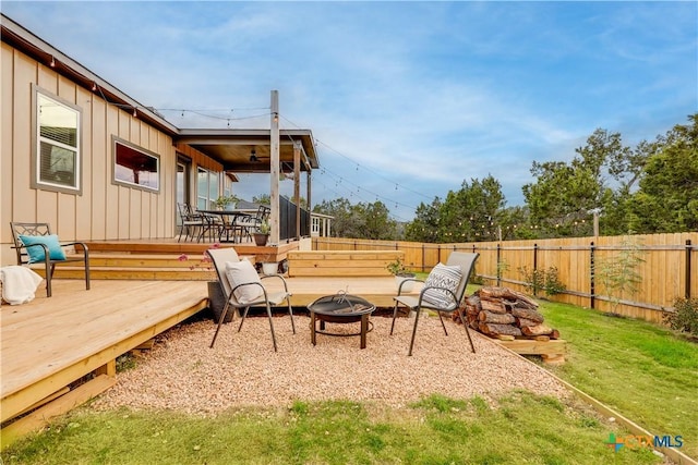 exterior space featuring an outdoor fire pit and a wooden deck