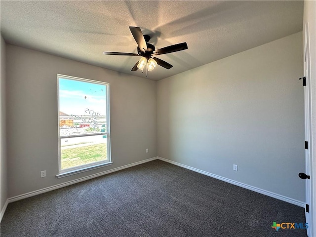 unfurnished room with dark colored carpet, ceiling fan, baseboards, and a textured ceiling