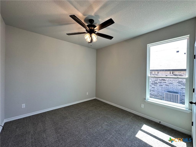 unfurnished room featuring dark carpet, ceiling fan, a textured ceiling, and baseboards