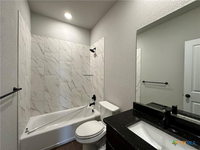 full bath featuring a textured wall, toilet, washtub / shower combination, wood finished floors, and vanity