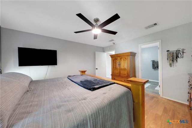 bedroom with visible vents, baseboards, a ceiling fan, and light wood-style floors