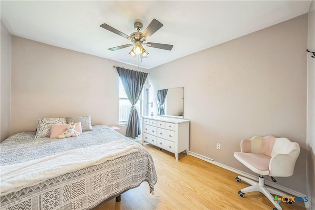 bedroom with light wood-style floors, baseboards, and a ceiling fan