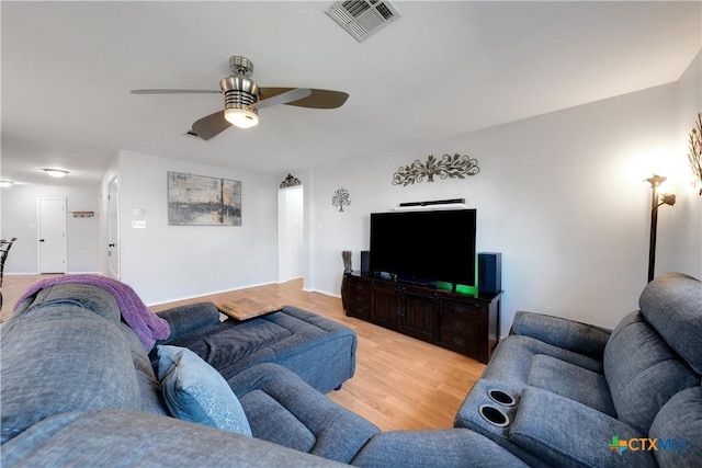 living area with light wood-type flooring, a ceiling fan, and visible vents