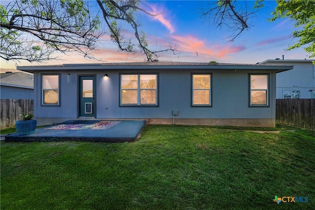 back of house with a yard, a patio area, and fence