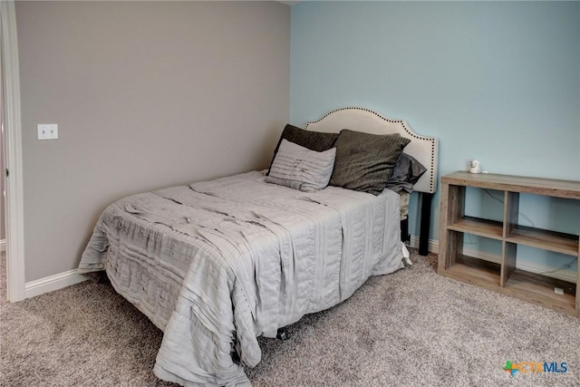 bedroom featuring carpet flooring and baseboards