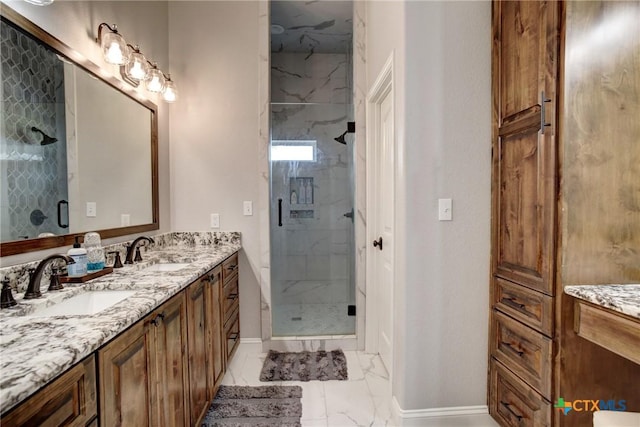 full bath with a stall shower, marble finish floor, and a sink