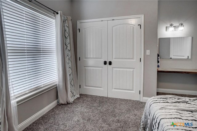 bedroom featuring baseboards, a closet, and carpet floors