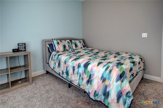 bedroom with baseboards and carpet floors