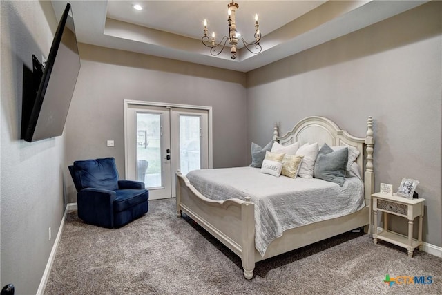 bedroom featuring a tray ceiling, french doors, carpet, and access to exterior