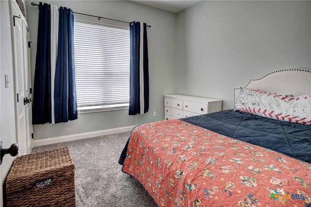 carpeted bedroom featuring baseboards