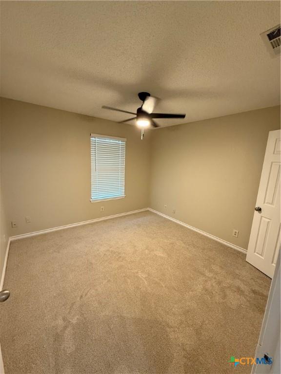 6601 Wells Fargo Rd, Killeen, TX 76542 - unfurnished room featuring ceiling fan, a textured ceiling, carpet, and baseboards