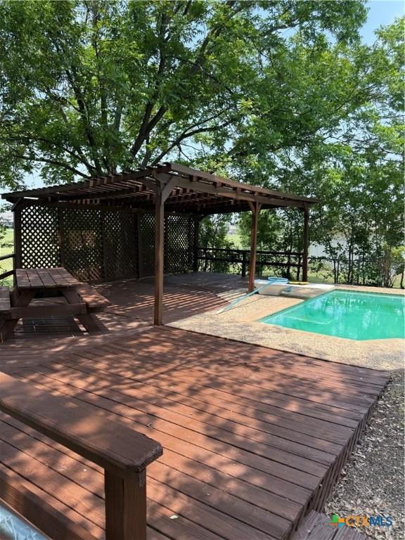 6601 Wells Fargo Rd, Killeen, TX 76542 - swimming pool featuring a wooden deck and a pergola