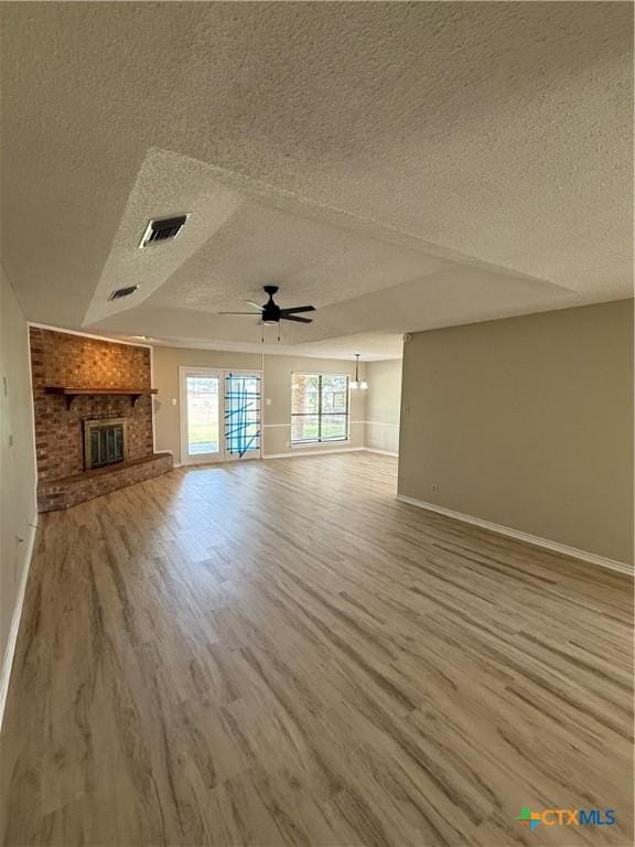 6601 Wells Fargo Rd, Killeen, TX 76542 - unfurnished living room with a textured ceiling, ceiling fan, baseboards, and wood finished floors
