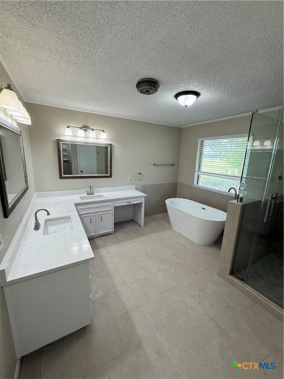 6601 Wells Fargo Rd, Killeen, TX 76542 - full bathroom featuring vanity, a stall shower, a freestanding tub, a textured ceiling, and crown molding