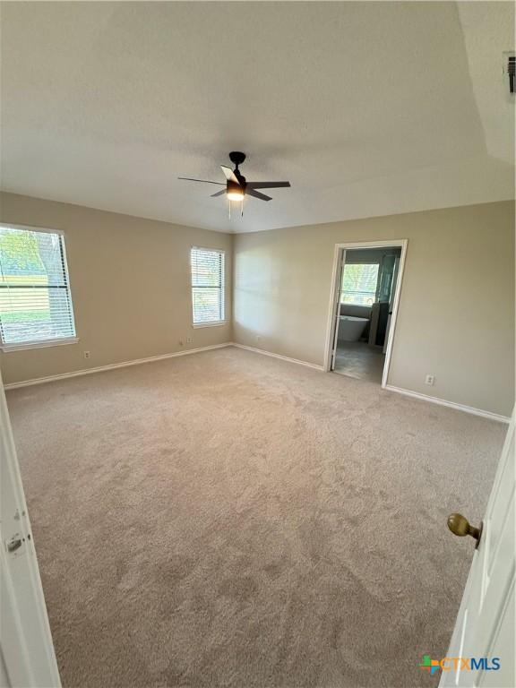 6601 Wells Fargo Rd, Killeen, TX 76542 - unfurnished room with light carpet, baseboards, and ceiling fan