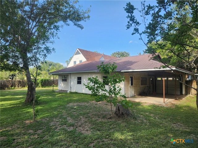 back of property with a patio and a yard